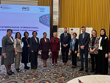 Several people pose for a group photo.