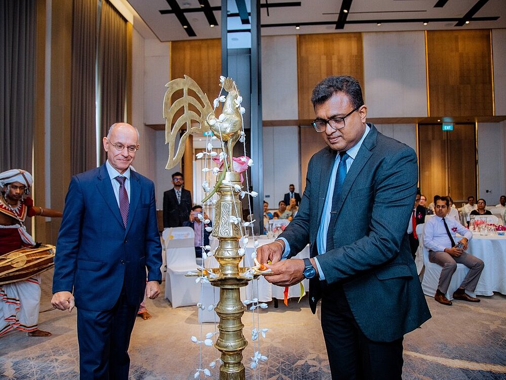 Two men are standing around a statue.