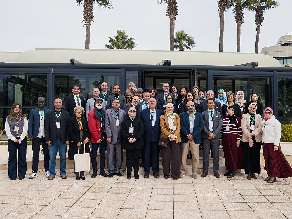 Several people pose for a group photo.