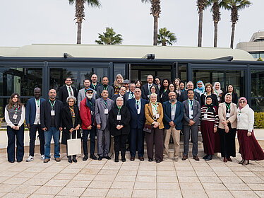 Several people pose for a group photo.