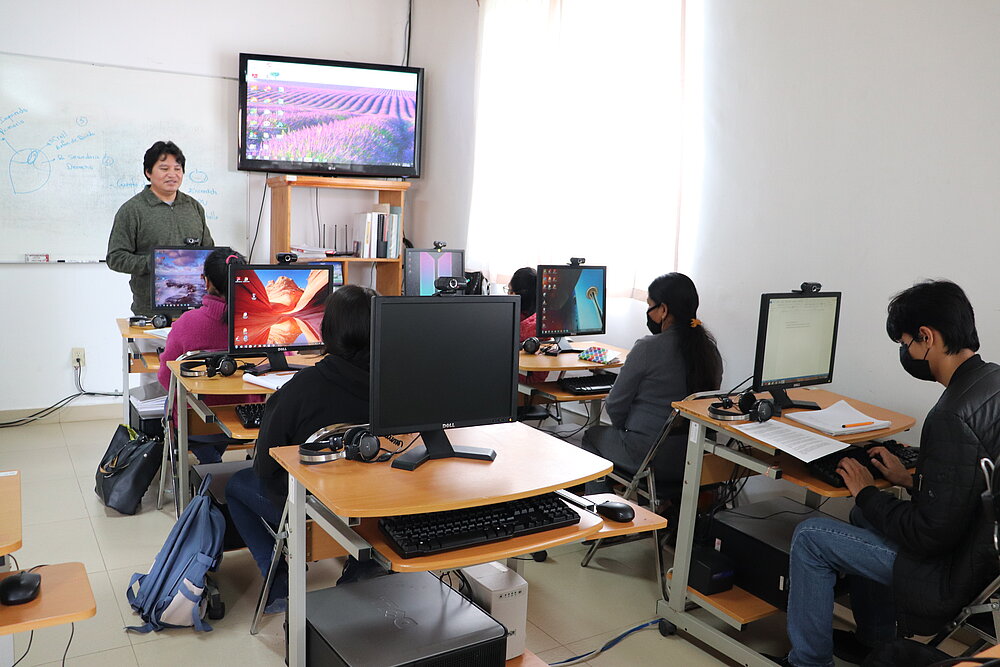 Persons in classroom with digital instruments