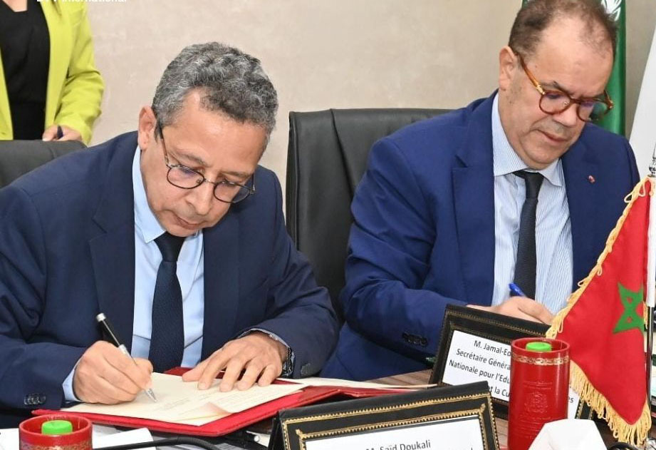 Formally dressed man signing a paper